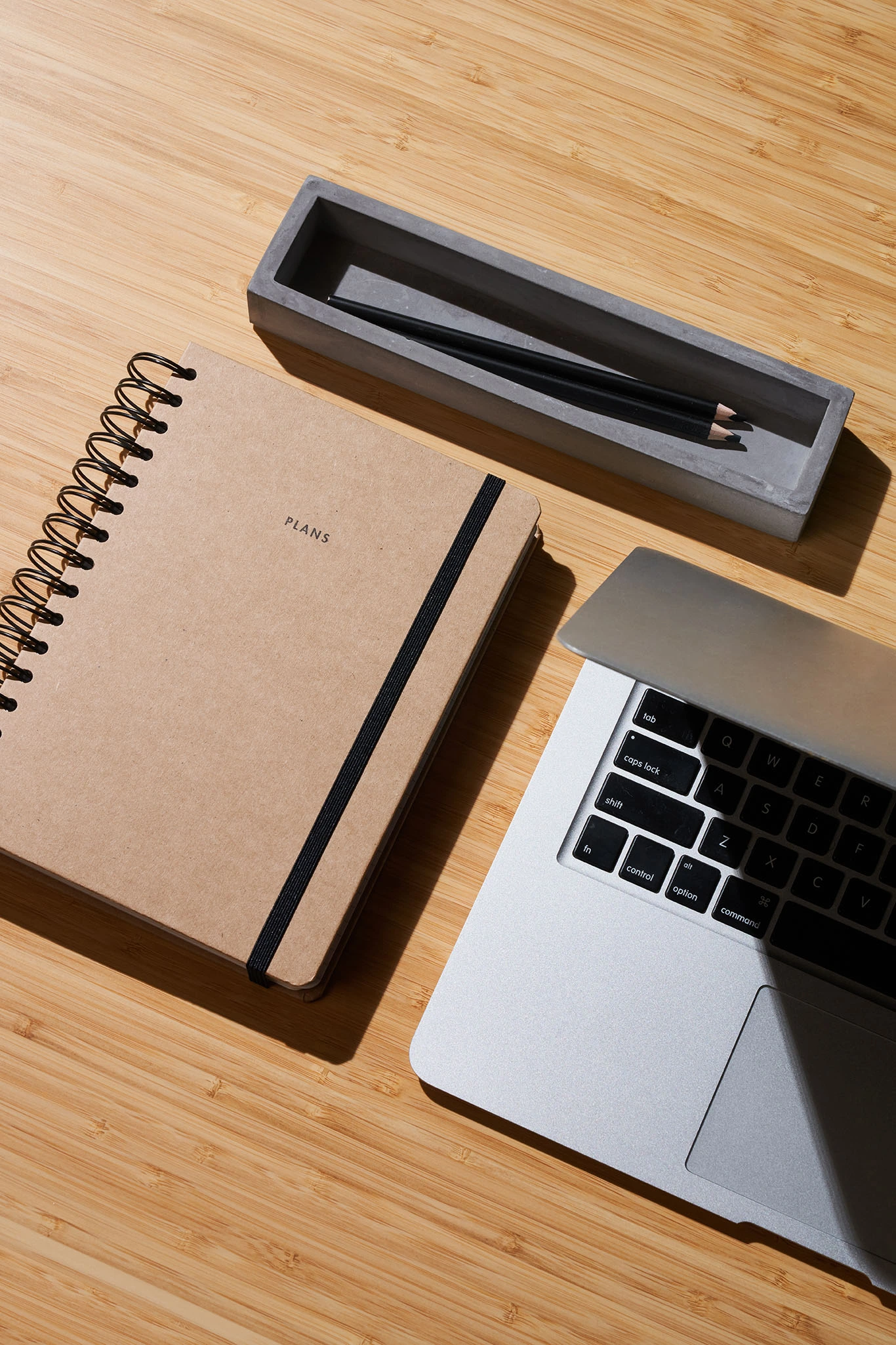 women desk with stationery, notebook and silver laptop
